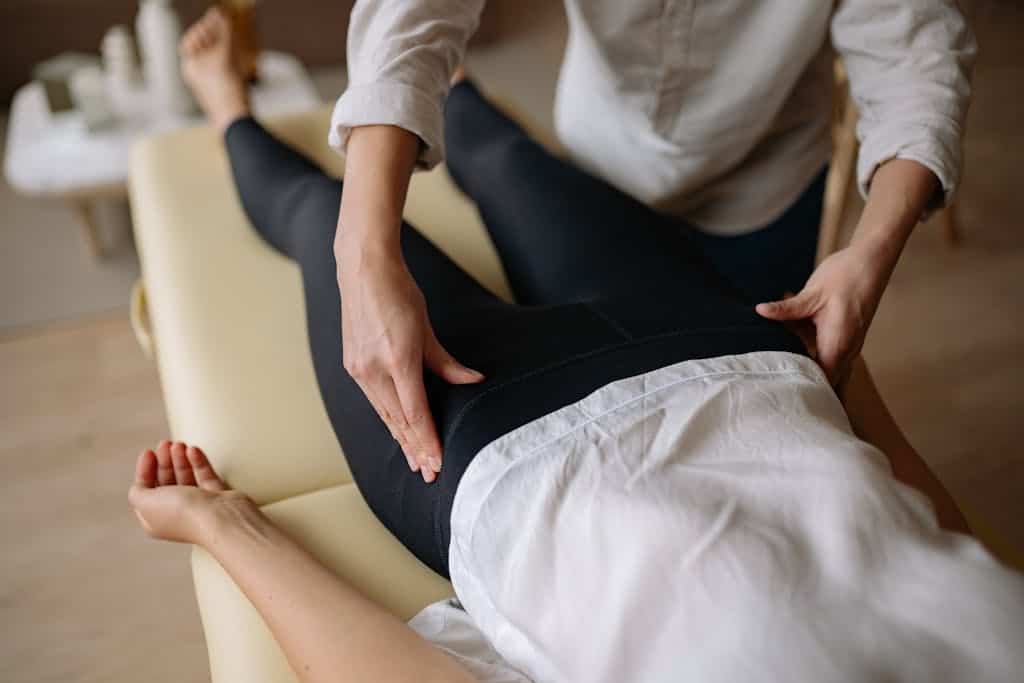 Massage therapist demonstrating proper body mechanics