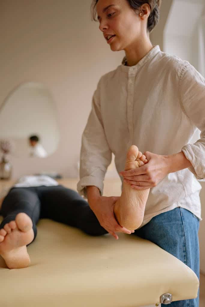 Massage therapist performing deep tissue massage showing hand and forearm engagement