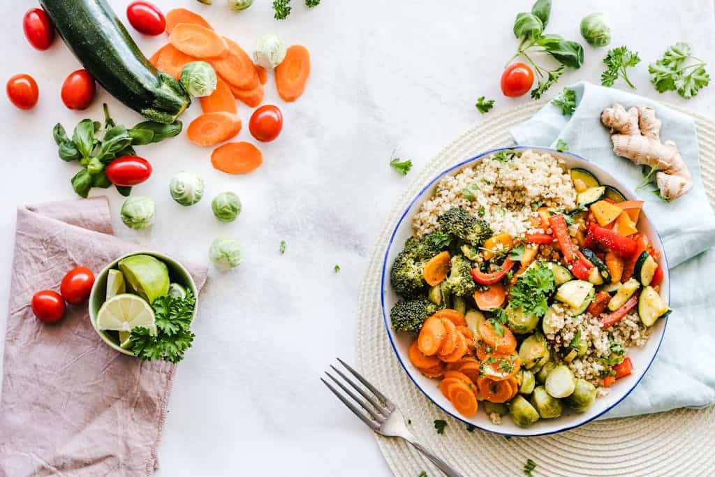 anti-inflammatory meal with colorful quinoa salad with fresh vegetables creates a healthy, balanced meal for massage therapist